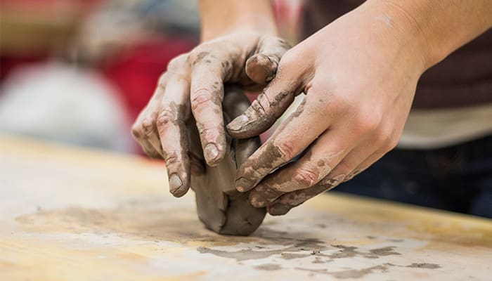 hands working clay